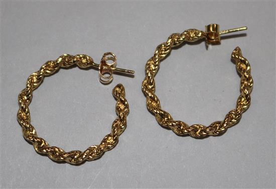A pair of yellow metal rope-twist hoop earrings